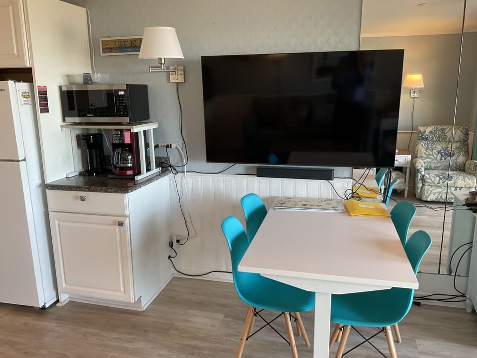 58” Samsung smart TV, Bose sound bar. Adjustable dining (office) table for four.