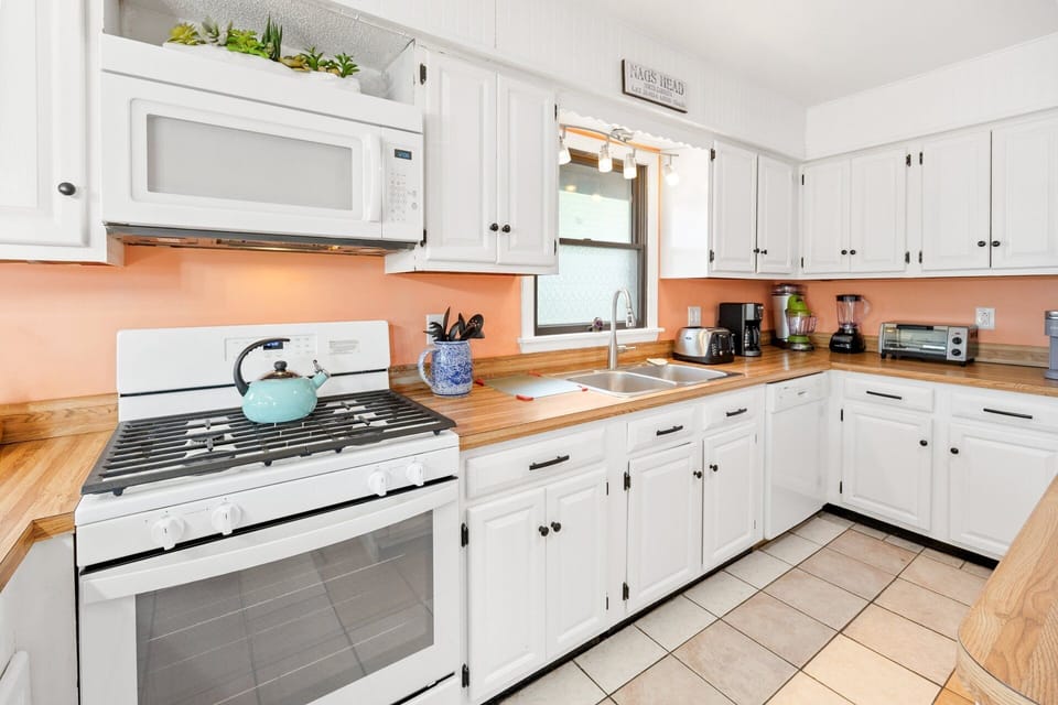 A fully stocked kitchen features ample prep space for home-cooked meals.