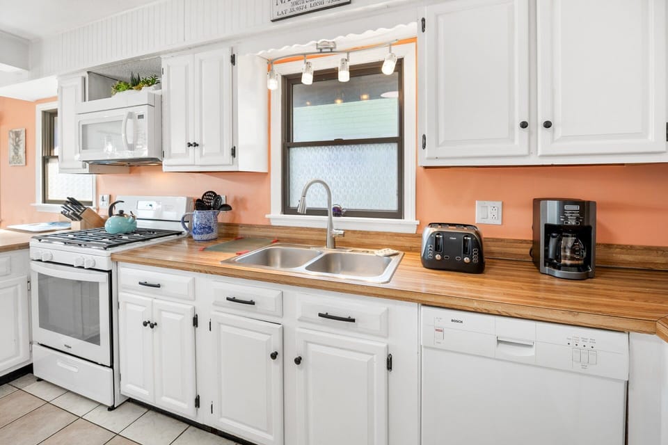 A fully stocked kitchen features ample prep space for home-cooked meals.