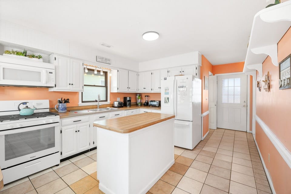 A fully stocked kitchen features ample prep space for home-cooked meals.