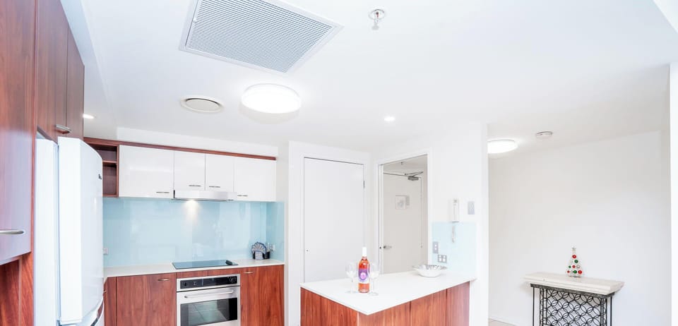 Sleek gourmet kitchen includes bench-tops, deducted range hood & dishwasher 🍽
