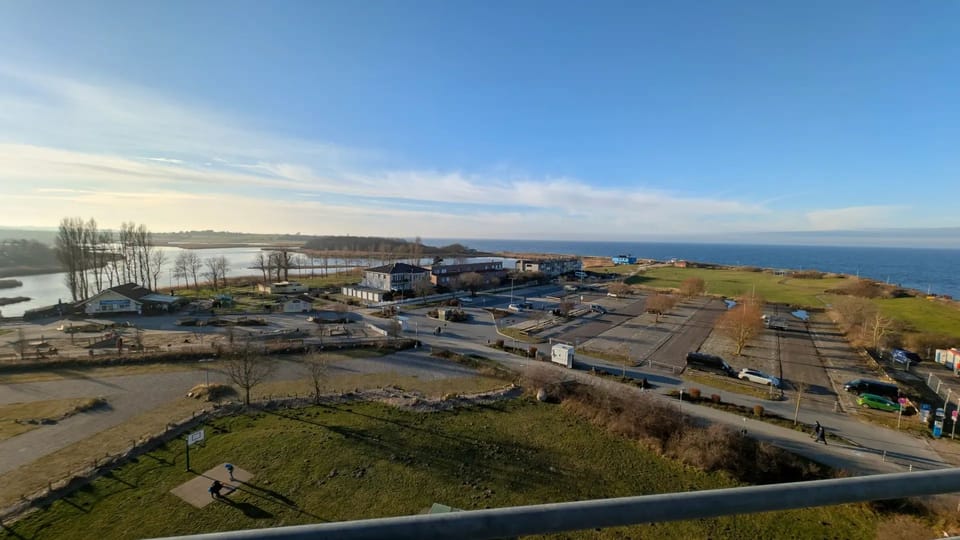Panoramic view over the parking lot, kite field and the Baltic Sea from the balcony