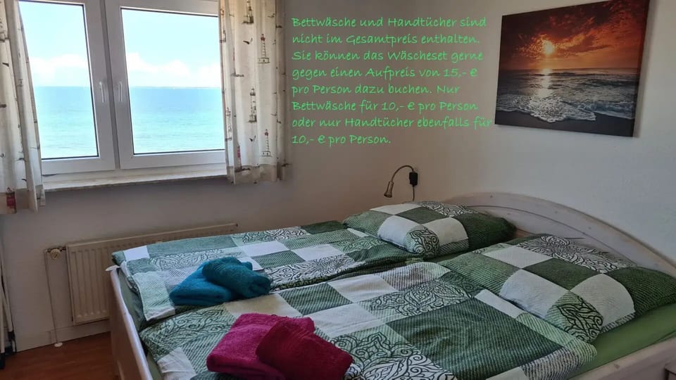 Bedroom with sea view and maritime wall decoration