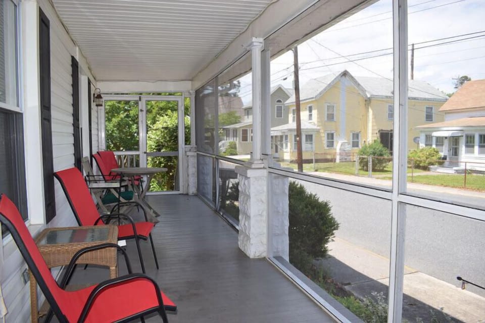 Relax and watch the world go by from the front screened porch.