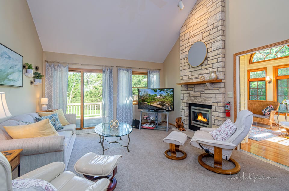 Living room with 4 seasons room visible off to right. 