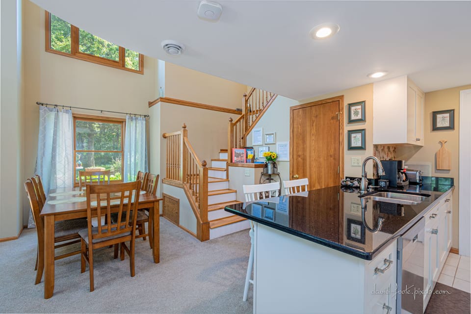 Dining area and kitchen near staircase