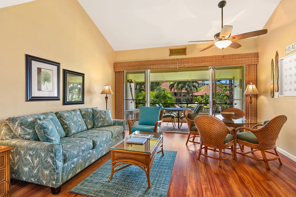 Relax in your tropical-themed living space where island breezes flow through open balcony doors, surrounding you with lush gardens and cozy furnishings perfect for unwinding after beach days.