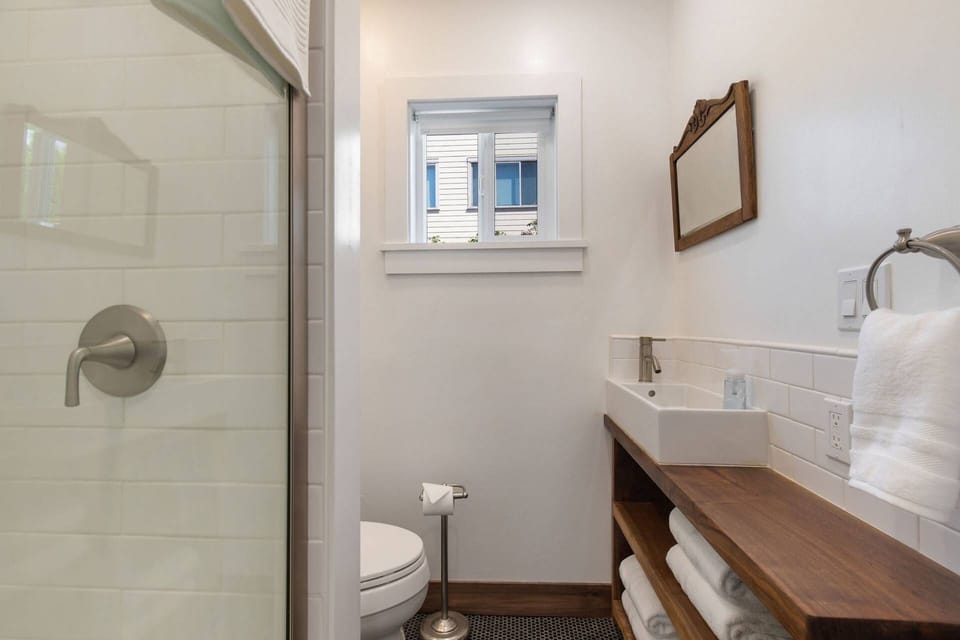 enjoy this beautiful glass shower and modern sink and countertop