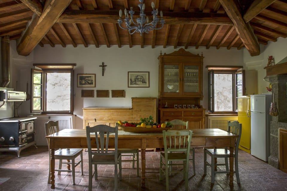 The kitchen has a ceiling of wonderful old wooden beams