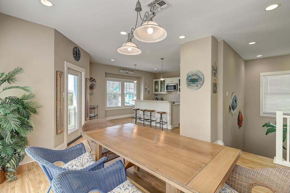 Gather around your spacious dining table where coastal charm meets modern comfort - perfect for morning coffee or evening meals together.