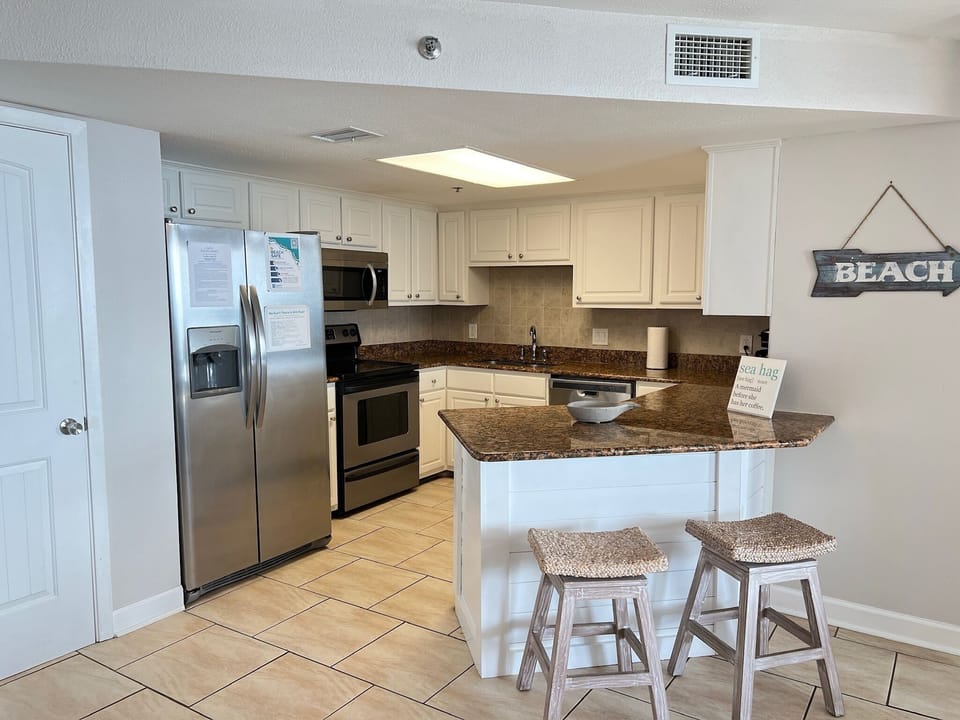 Kitchen with all the essentials such as pots, pans, cooking utensils, plates, and glassware.  Also included are coffee maker, toaster, blender, air fryer, and a mixer