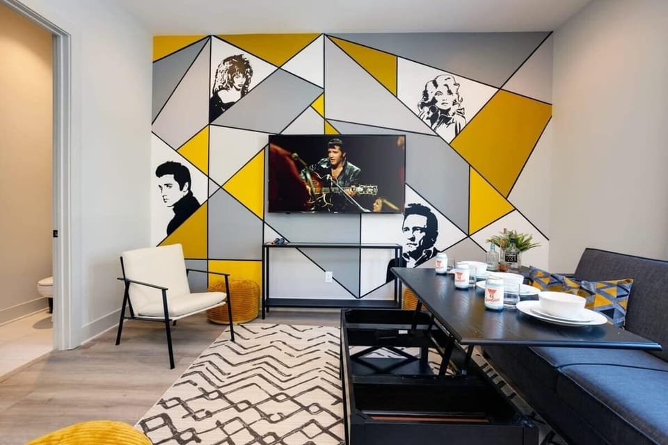 Nashville musician mural, sofa, and convertible table in the themed room give your group a second living space full of personality and ready for game night or late-night hangouts