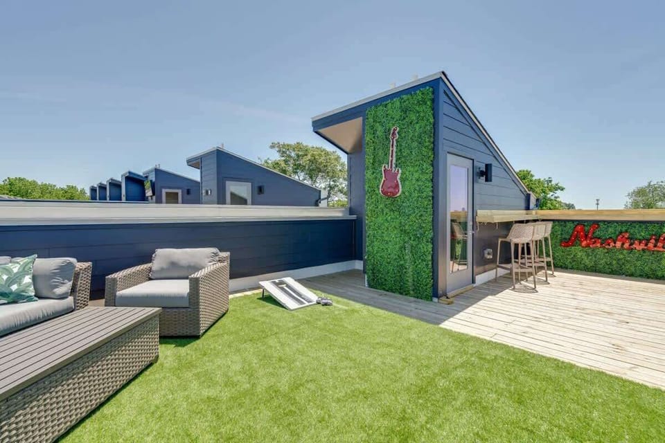 Rooftop bar with seating and artificial turf creates an outdoor living room where your group can gather with a drink after the games wind down for the night