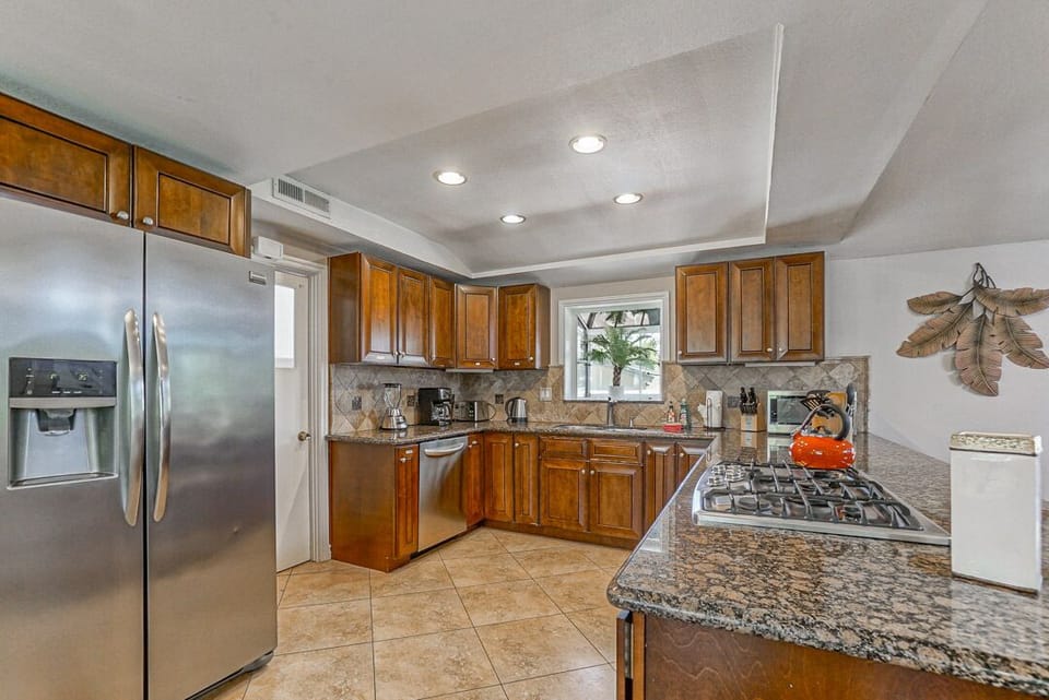 - Spacious kitchen with granite counters and wood cabinets   - Stainless appliances and gas stove make cooking simple   - Open design with plenty of space for preparing meals