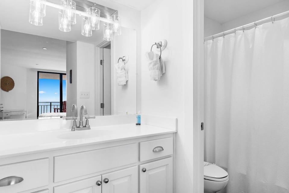 Refresh in your bright, modern bathroom with dual sinks and elegant fixtures, perfect for your morning routine.