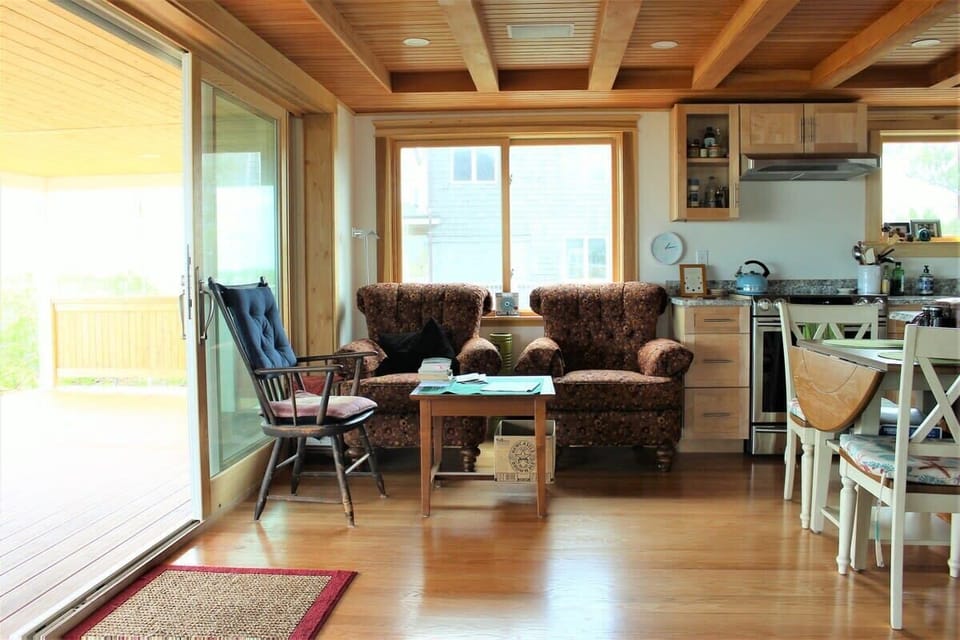 Open concept kitchen and living room with large windows to enjoy plenty of natural light.