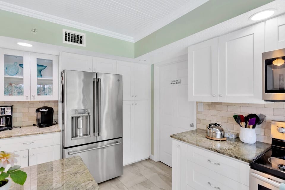 Kitchen with pool and pond views. Dishwasher. Microwave. Oven.