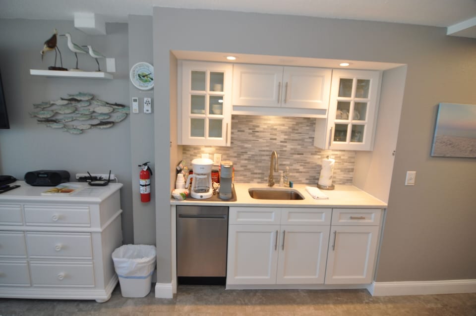 Cozy kitchen nook with large stainless steel sink, dishwasher & coffee station 