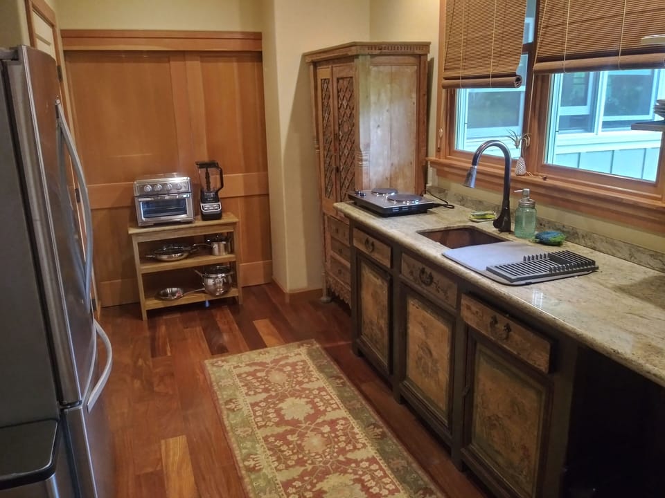 Another view of the kitchen area. There is also a Weber gas grill outside.