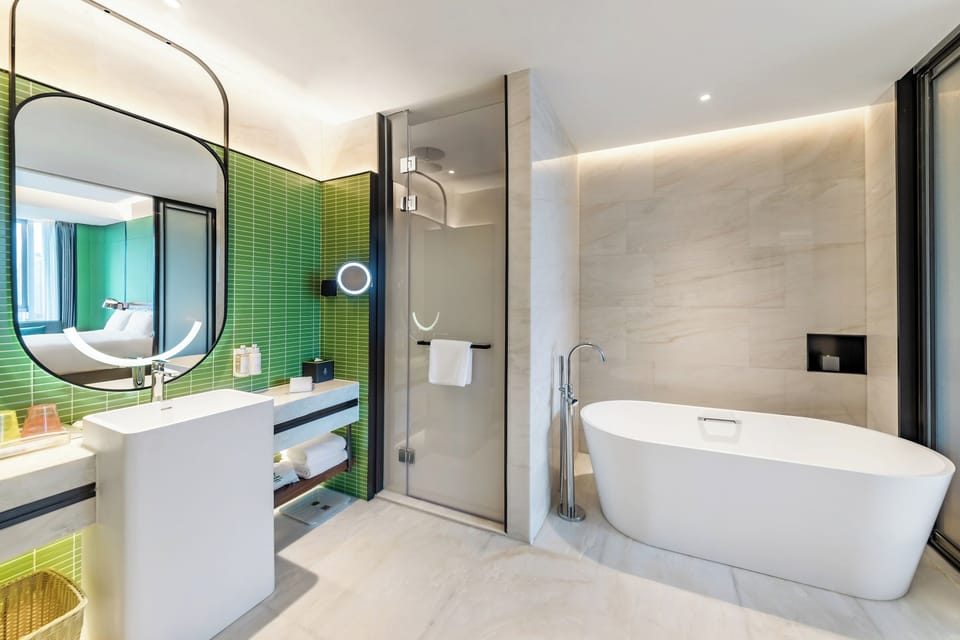 Suite, 1 King Bed | Bathroom | Rainfall showerhead, free toiletries, hair dryer, bathrobes