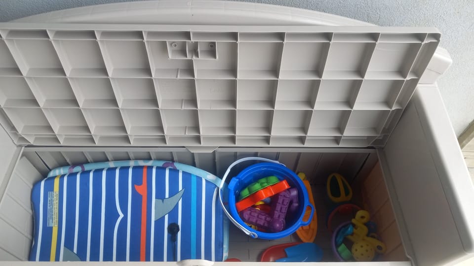 Beach and pool toys in patio bench