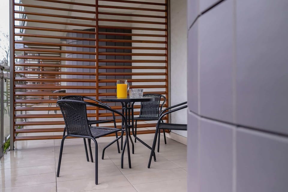 The balcony's stylish design complements the apartment's decor. 