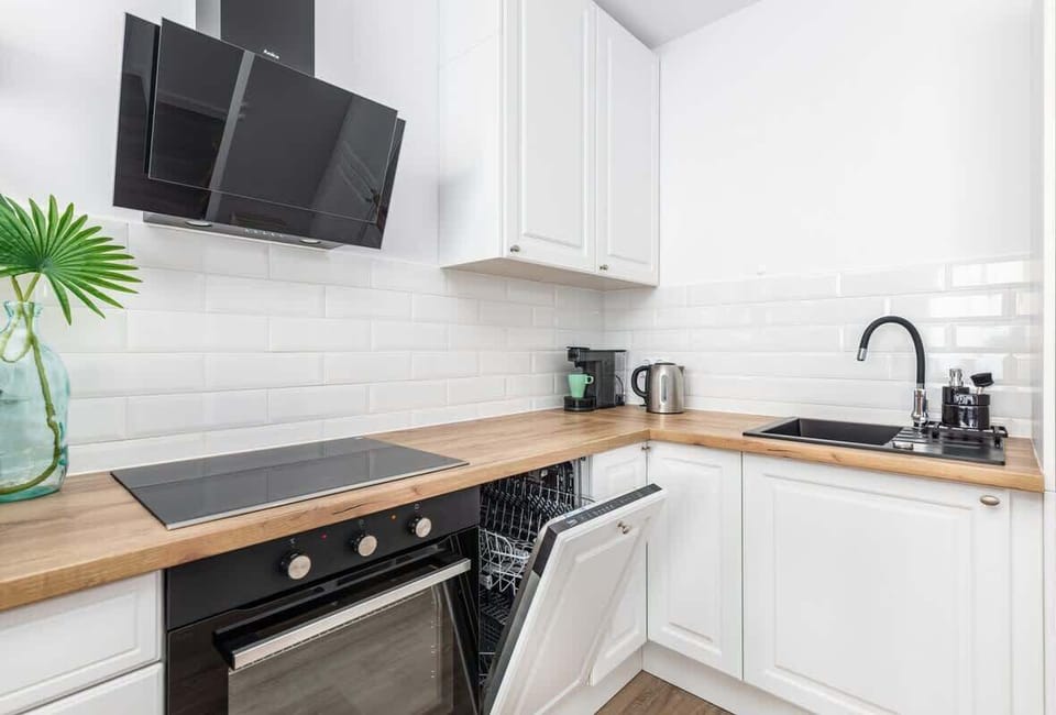 Kitchenette with plenty of kitchen utensils and dishes. 