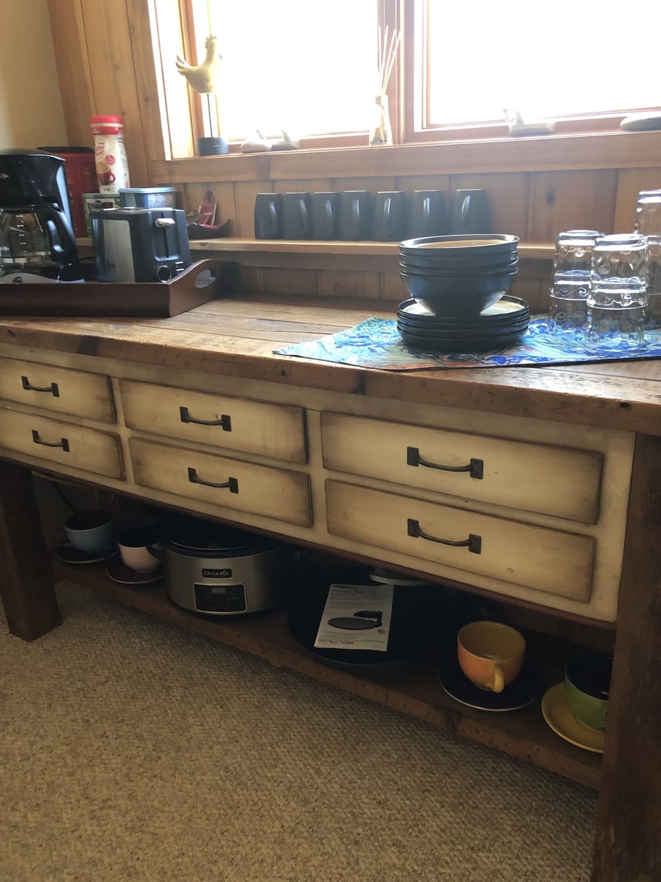 Coffee maker, toaster, crockpot, pizza oven, microwave, and mini fridge.