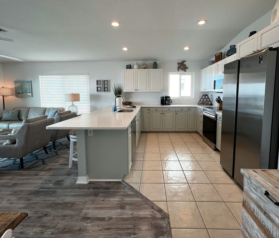Beautifully updated kitchen with new quartz counters and stainle - Beautifully updated kitchen with new quartz counters and stainless steel appliances- overlooking the beach and open concept living room and dining room.