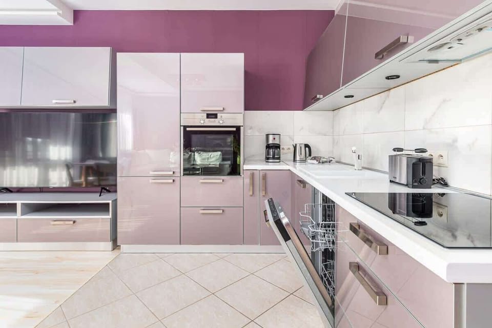 Kitchenette with oven and refrigerator. 