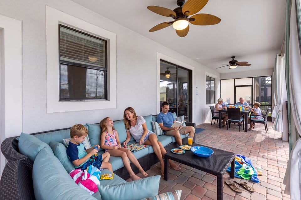 Lanai has an outdoor sectional, table with seating for 8 & curtains for shade