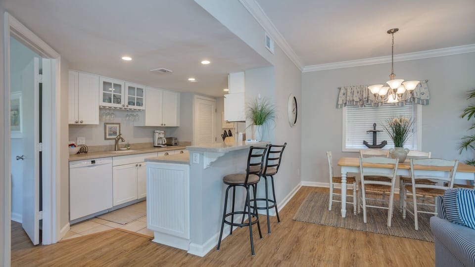 The efficient layout keeps everything within reach—ideal for quick breakfasts or relaxed dinners after a day at the beach.