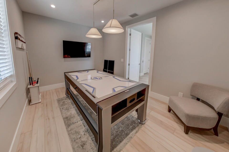 From pool to air hockey to table tennis—this game room has it all, plus a Smart TV!