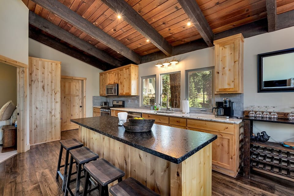 A stylish kitchen with wood accents, modern appliances, and ample counter space.