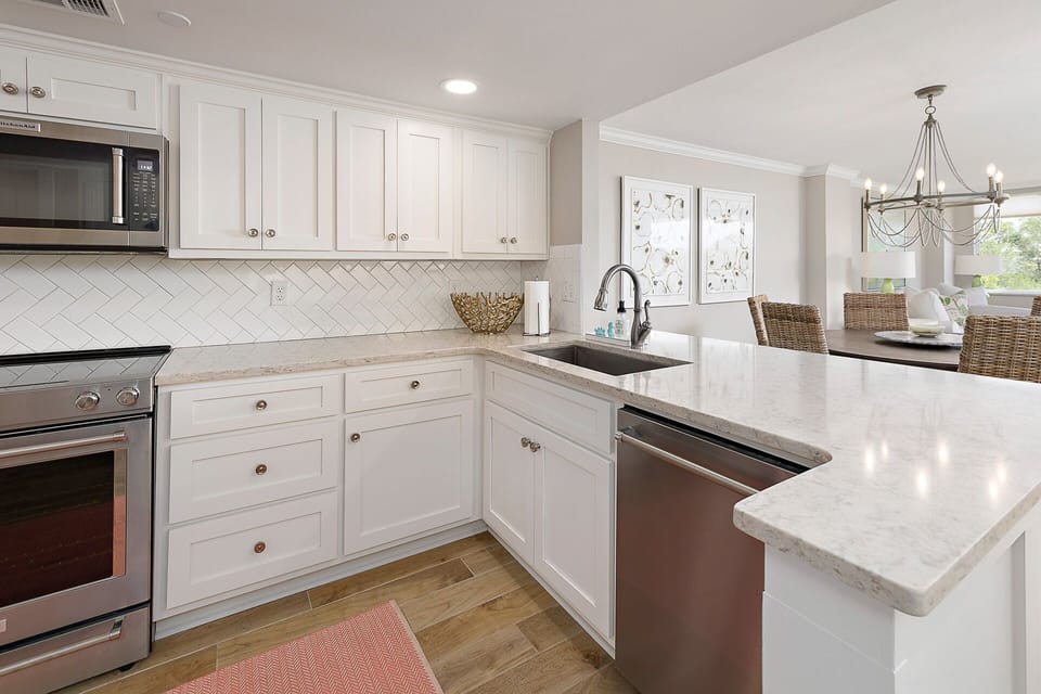 The bright, open kitchen looks into the Dining and Living Area