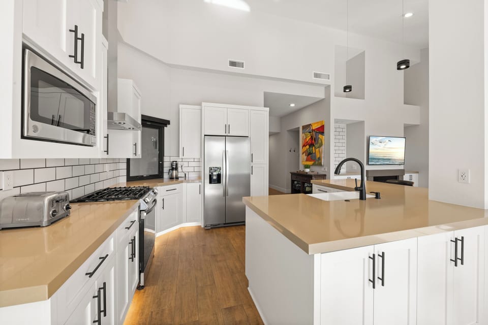 Kitchen opens to living room and dining area