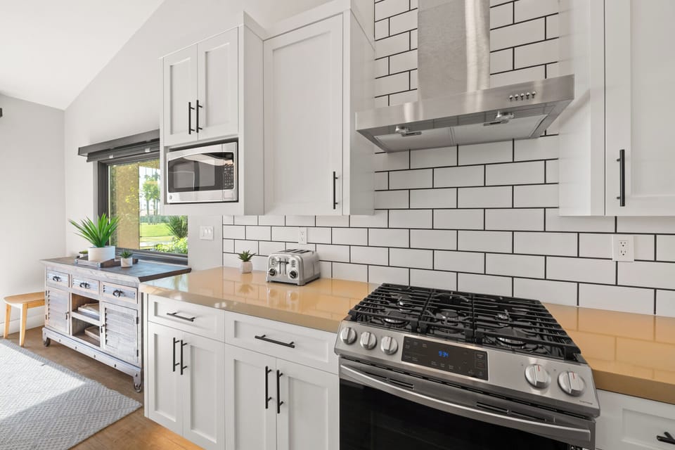 Kitchen has gas oven and range, hood, and microwave
