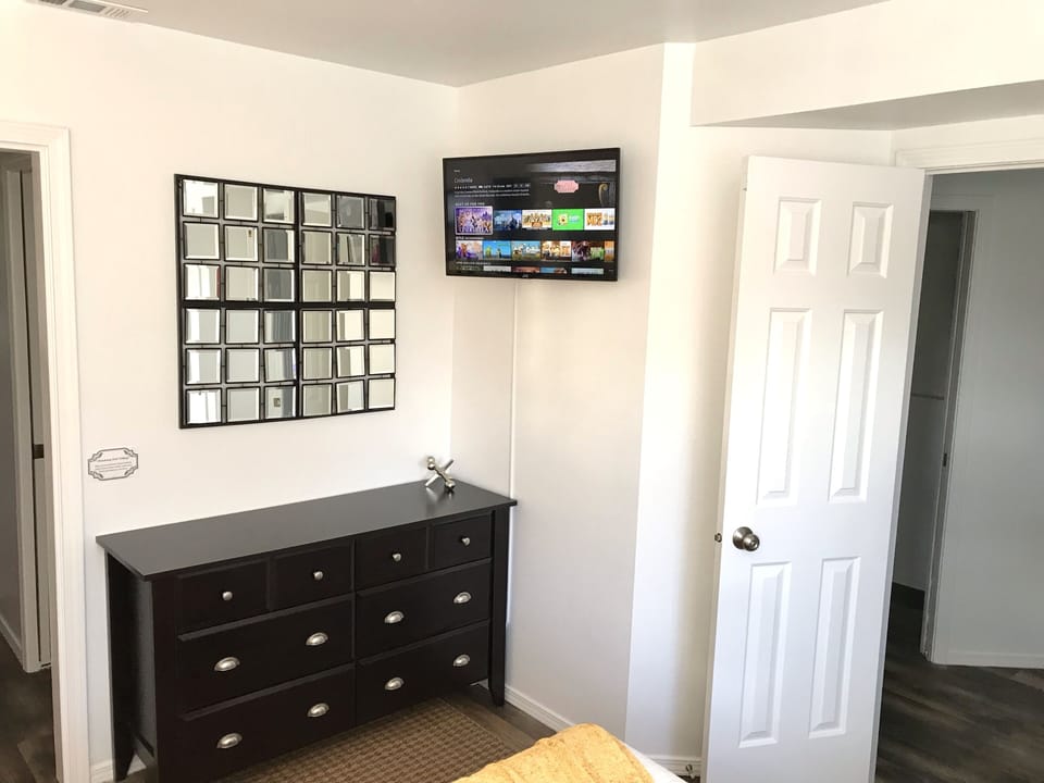 Master bedroom with mounted TV.