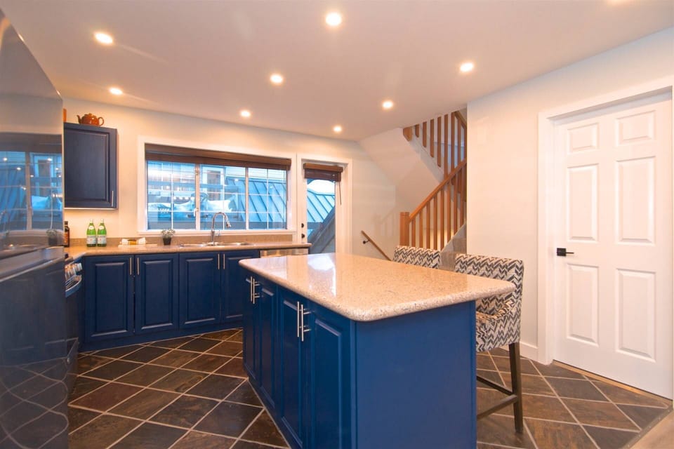 Newly renovated kitchen with center island with two chairs