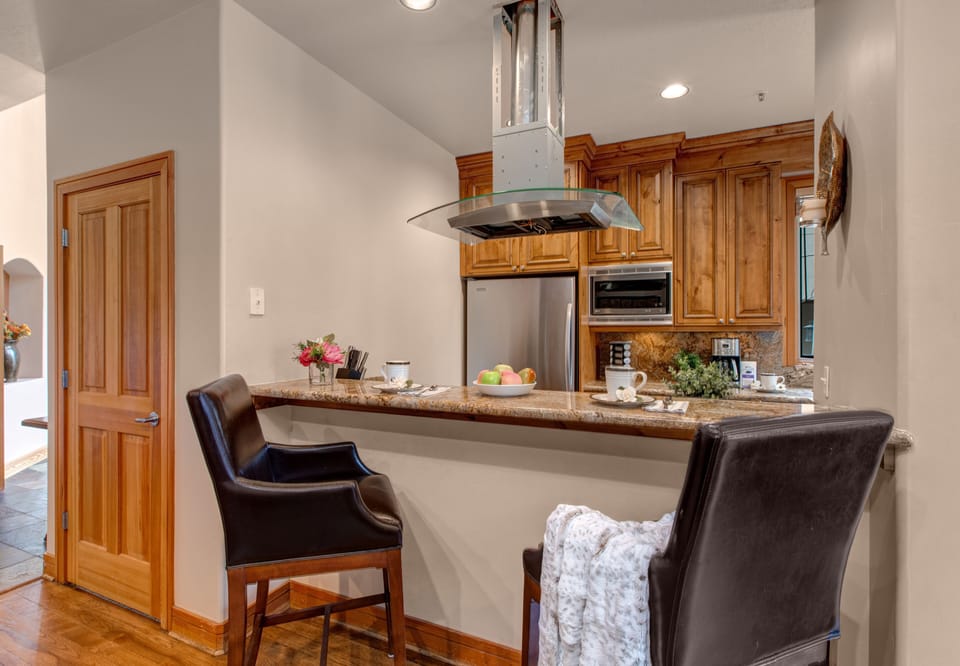 Fully Equipped Kitchen with stainless steel appliances, beautiful stone countertops, private patio access and bar seating for 2