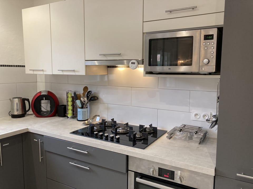 Microwave and Fridge/freezer 5=burner gas stove, kettle, Dolce Gusto coffee