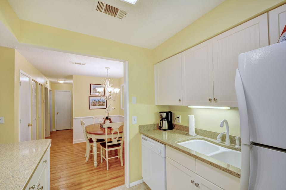 Kitchen & Dining Connection - This galley kitchen opens straight to the dining table—perfect for pancakes, pastas, or family-style nights in.