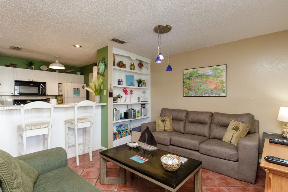 Unwind in your tropical-themed living space with plush seating and colorful accents that bring island vibes indoors.