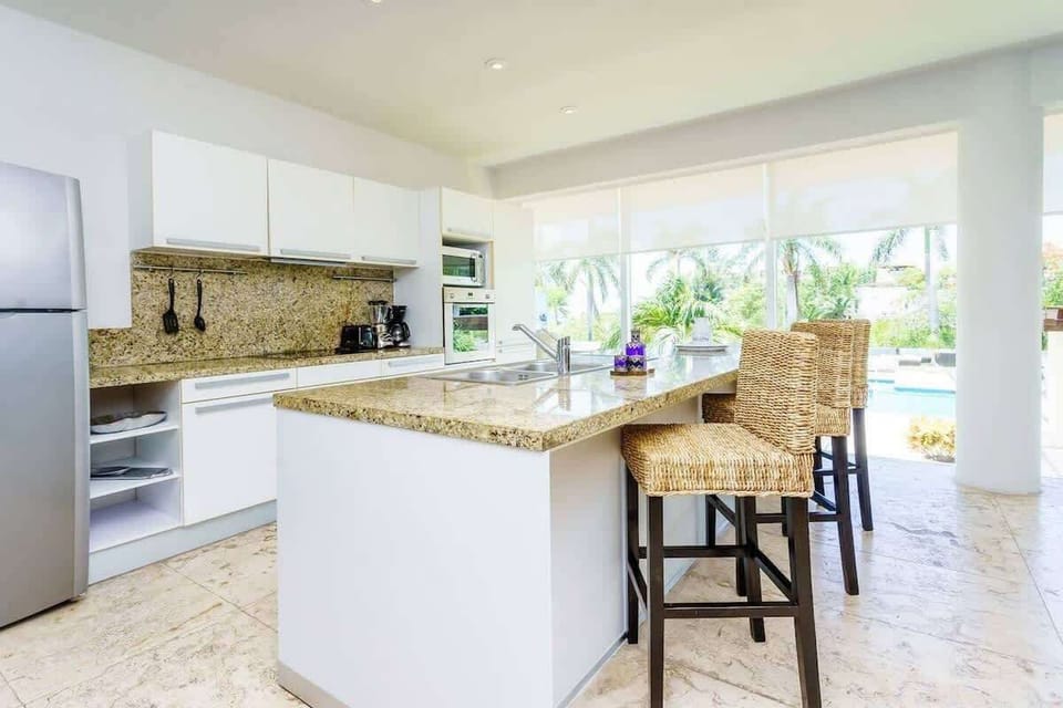 The condo has huge floor-to-ceiling windows overlooking the pool area