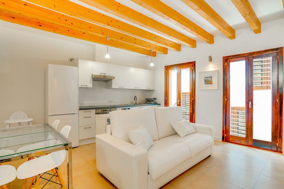 This photo shows the first floor of the Duplex apartment, with the kitchen and dining area, and also a sofa-bed.