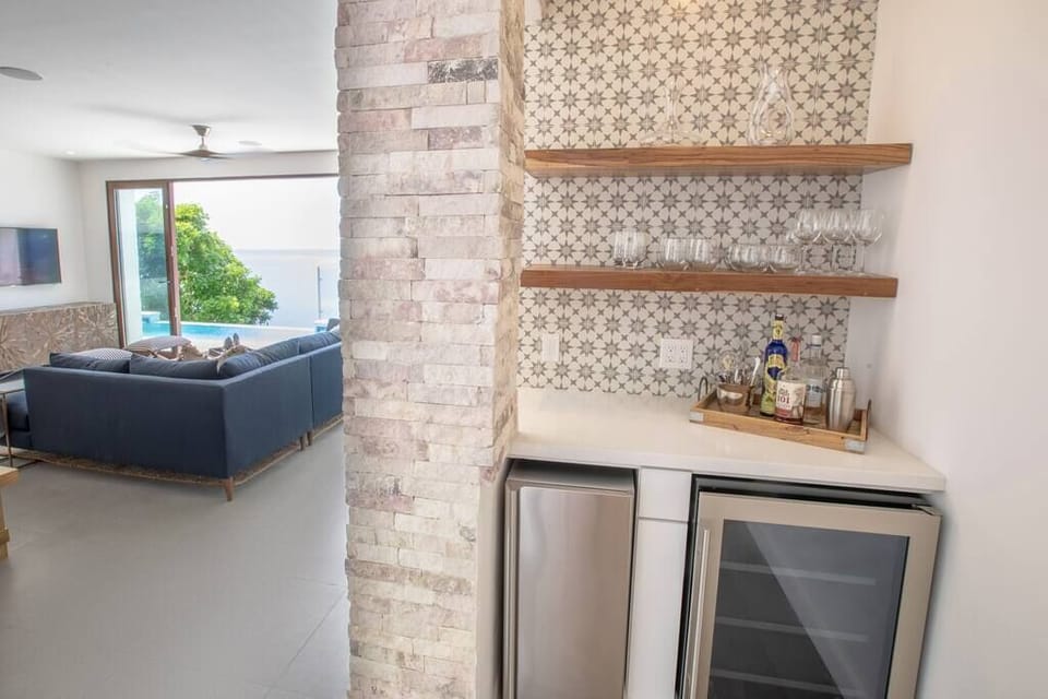 Bar area just off the kitchen with an ice maker and beer/wine fridge