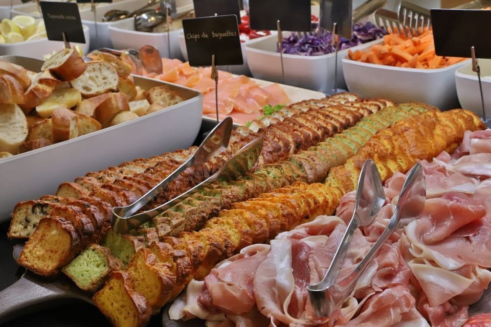 Breakfast spread in the on-site restaurant — cold cuts, bread, and pastries before a day out in the Gorges.