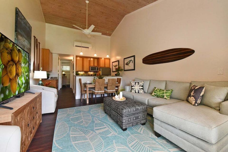 Enjoy a spacious layout with a sectional sofa, surfboard decor, and a kitchen that's perfect for casual meals and entertaining.