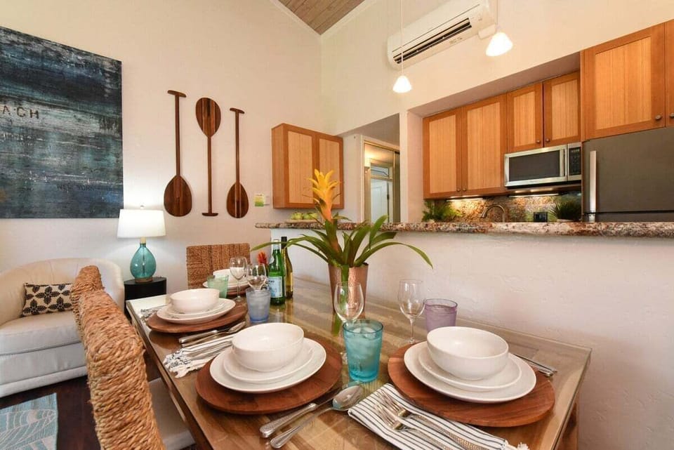 Gather around a table set for four, accented by tropical flowers and paddle-inspired wall decor for a true island vibe.