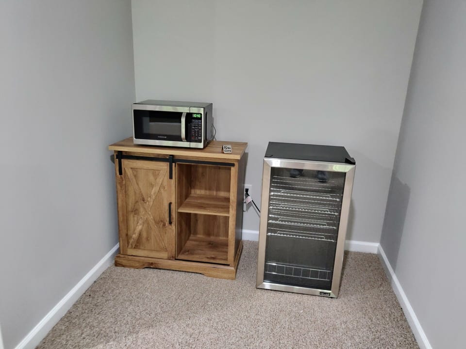 Drink cooler and microwave in gaming / media area.  